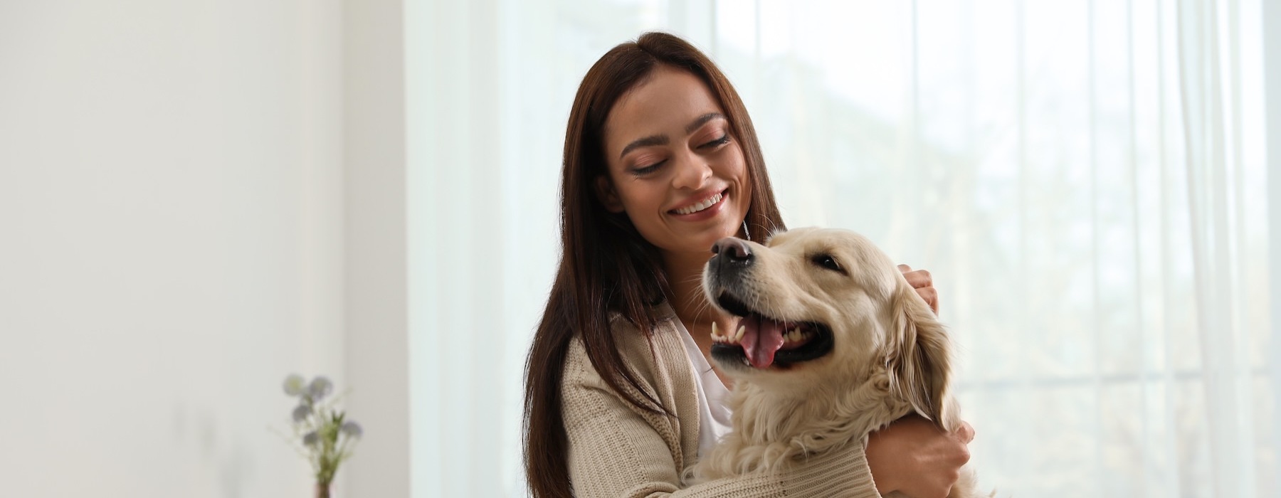 a woman petting a dog